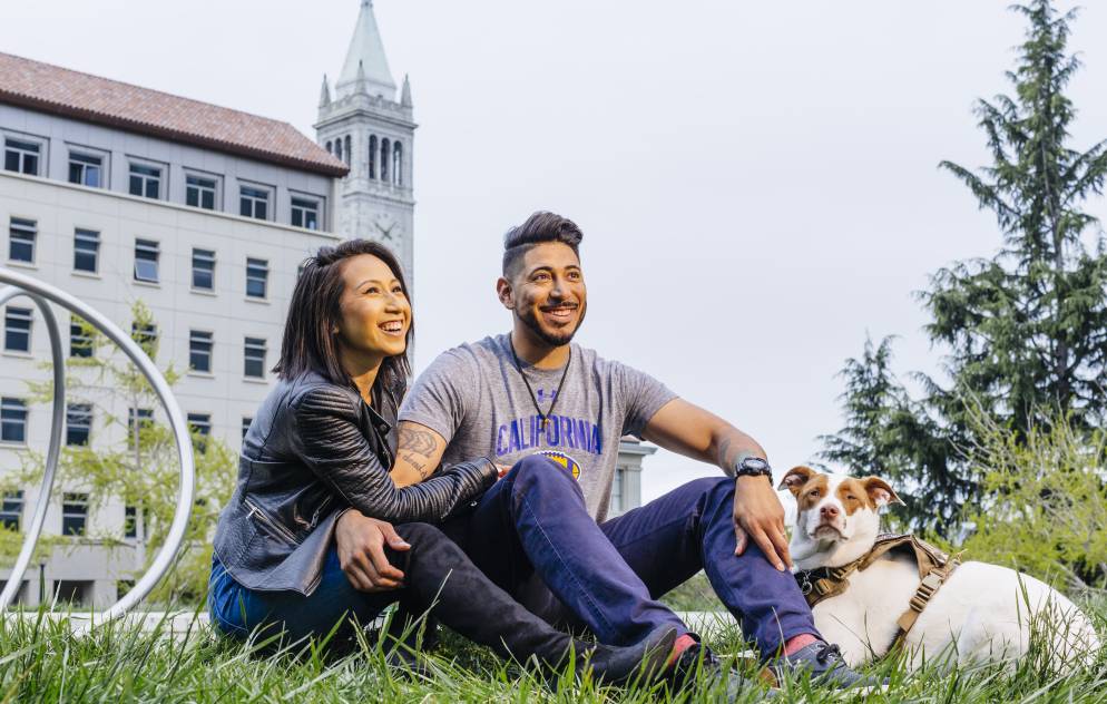 Brian and Monica Vargas with their dog in front of Berkeley's Hearst Mining building. 